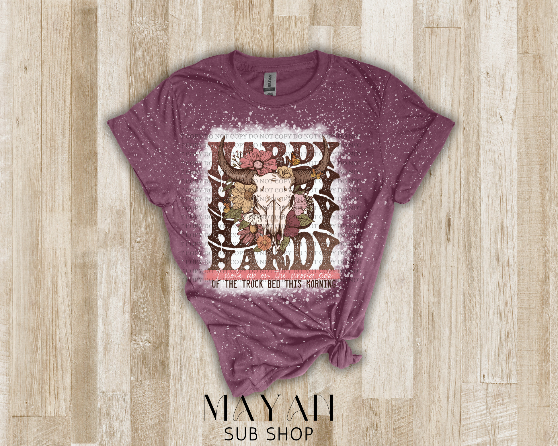 Country song shirt with cattle head and flowers in heather maroon shirt.
